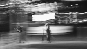 grayscale photo of girl walking on street