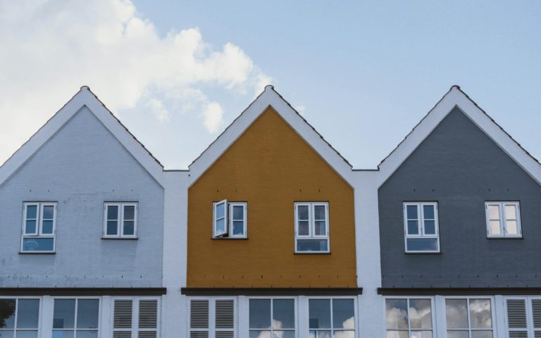 white and brown concrete house under blue sky during daytime